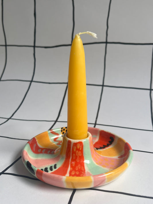 Candle holder decorated with patterns using underglazes. 