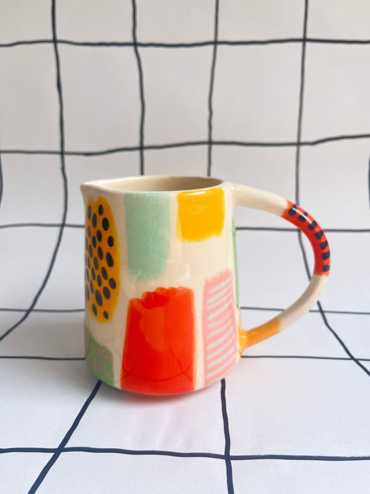 Colourful jug with abstract patterns on a white background with black lines